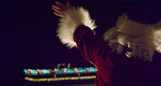 santa waving on a boat